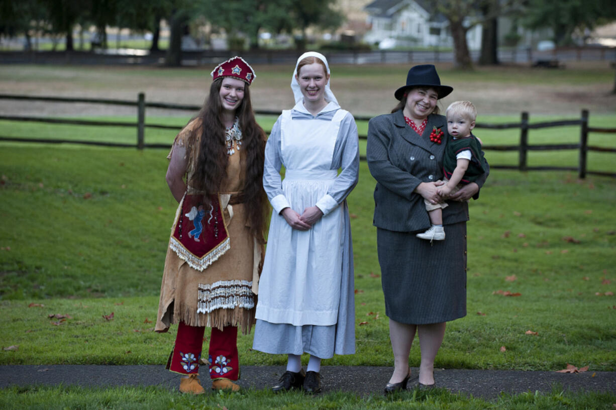 Megan Wilcox, representing 1880s Paiute leader Sarah Winnemuca, from left; her sister Tiffany Wilcox, as a World War I nurse; and Shelly Toews and her son Nathaniel, 17 months, in styles from the 1940s, model clothing of different eras at the Fort Vancouver National Historic Site.