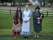 Megan Wilcox, representing 1880s Paiute leader Sarah Winnemuca, from left; her sister Tiffany Wilcox, as a World War I nurse; and Shelly Toews and her son Nathaniel, 17 months, in styles from the 1940s, model clothing of different eras at the Fort Vancouver National Historic Site.