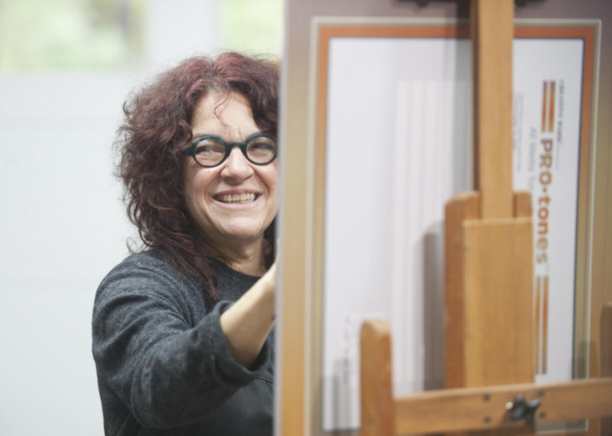 Local artist Hilarie Couture works on a portrait as part of her &quot;Founding Mothers&quot; art project.