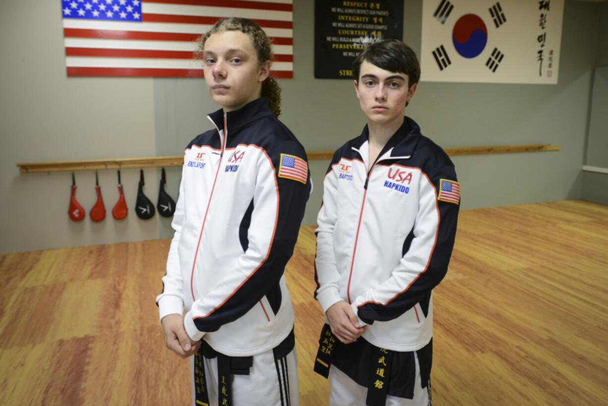 Sixteen-year-old Enzo LaFont, left, and 17-year-old Aiden Bartocci, right, take a break during practice at King Tiger Martial Arts in Vancouver.