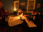 Re-enactors portray 1840s Hudson&#039;s Bay Company officials during a Fort Vancouver lantern Tour.