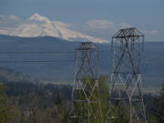 High voltage power lines are seen looking east from Oak Creek Park as Mt. Hood is visible in the background in April in Camas.