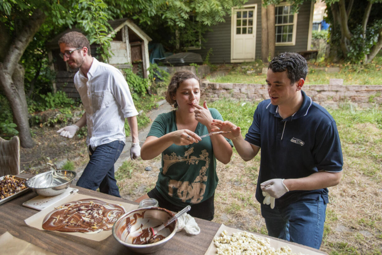 While the chocolate cools, there&#039;s always time for a taste. From left, Miles Bloch, Alissa Hartnid and Evan Smith sample the creations they made at Moishe House.