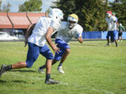 Sophomore wide receiver and defensive back Darien Chase, right, runs through a play with his teammates at Mountain View High School.