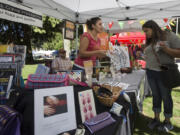 Jessica Babcock recommends a book about Palestine at the Rachel Corrie Foundation booth Saturday at the 13th annual Peace and Justice Fair in Esther Short Park in downtown Vancouver.