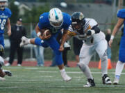 Mountain View quarterback Andre Scheer barrels towards Hudson&#039;s Bay defensive tackle Casey Wishon at McKenzie Stadium on Friday, September 30, 2016. Mountain View beat Hudson&#039;s Bay 34-16.