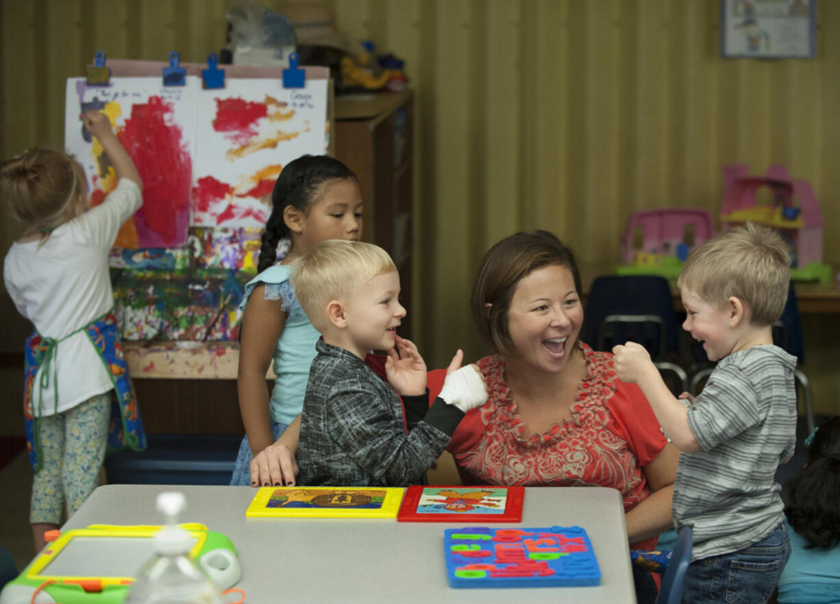 After a brief disagreement, preschooler Sam Kolodko, 4, left, shares a fist bump with classmate Aiden Epp, 4, right, as teacher Kendra Yamamoto looks on at Martin Luther King Elementary School on Thursday morning. Pictured in the background is classmate Quetzalli Flores Garcia, 4, in blue.