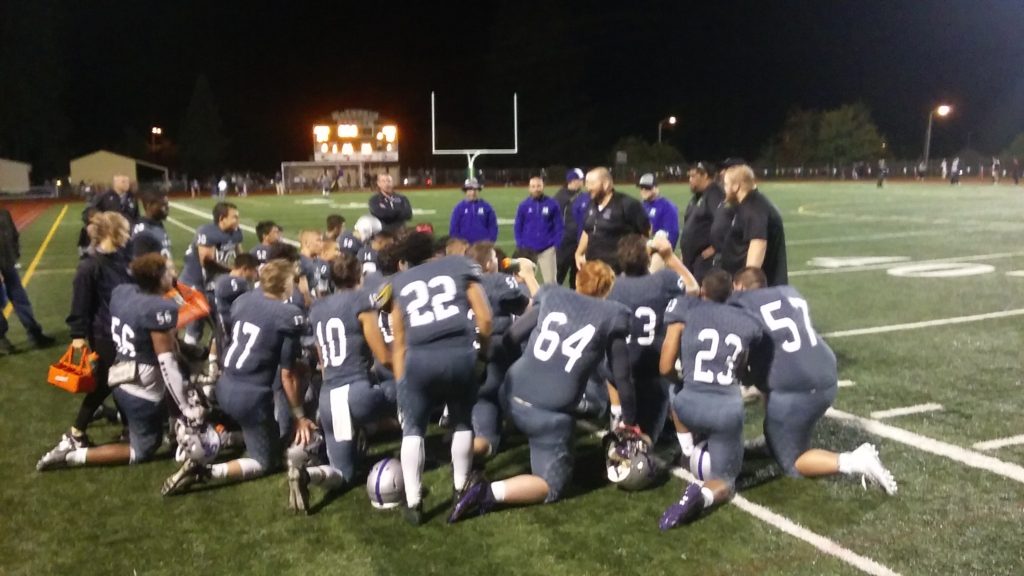 Heritage coach Matt Gracey talks to his players after the Timberwolves 21-12 win over Prairie.