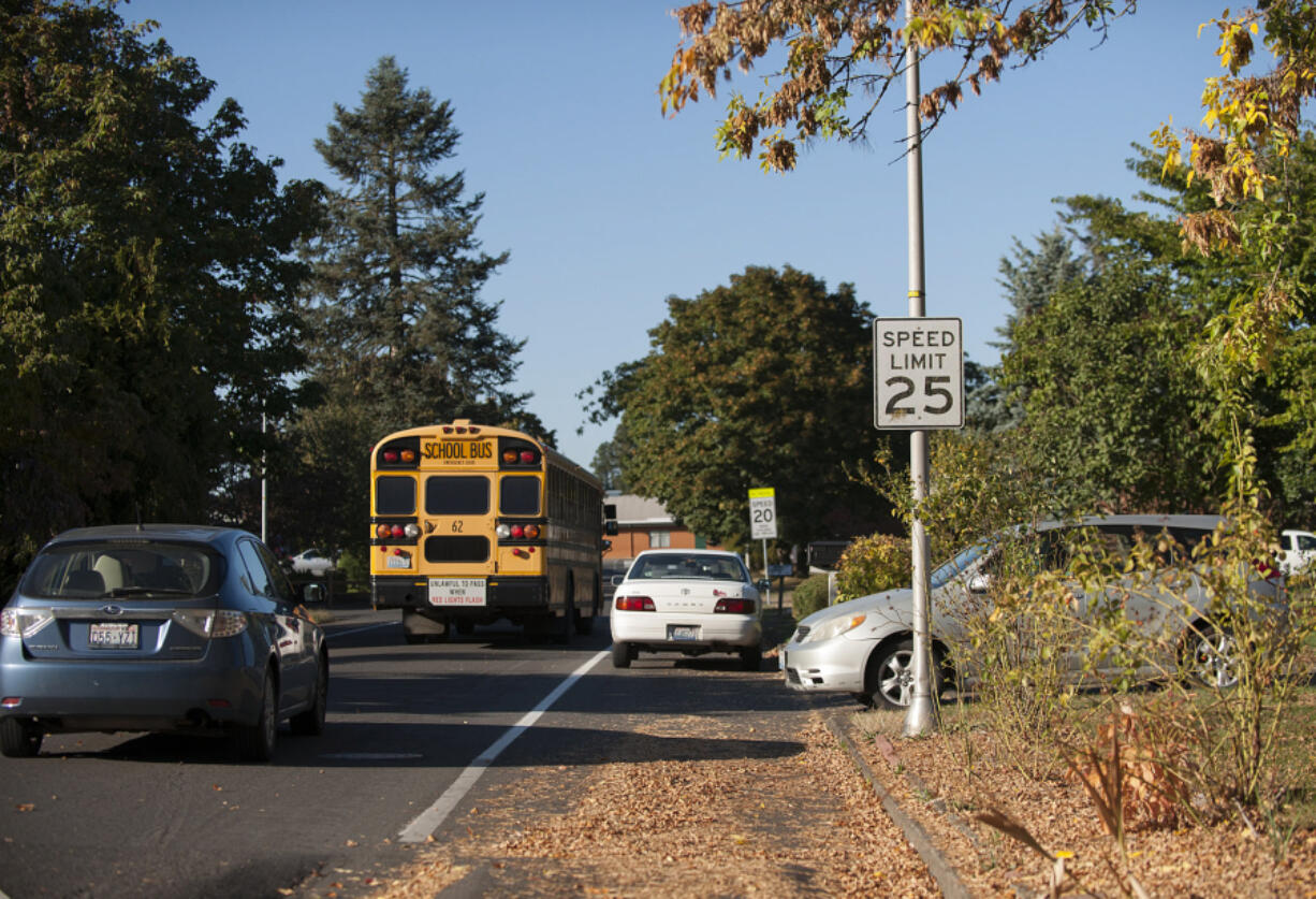 Motorists navigate around a parked car along Northeast 81st Avenue on Sept. 28. Residents say the street has become a popular parking spot for residents of nearby apartments.