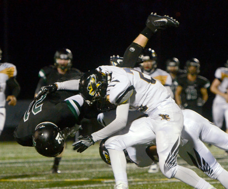 Hudson's Bay cornerback Makenzie Brown-Rushing throws Woodland wide receiver Tyler Flanagan in Woodland on Friday, September 23, 2016. Hudson's Bay beat Woodland 39-24.