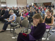 Mary Allison of Amboy, foreground, mourns her sister, Sharon Allison, as taps is played during the National Day of Remembrance for Homicide Victims ceremony Monday at the Clark County Public Service Center. Allison died from blunt-force head trauma in her Vancouver apartment in May 2015. Investigators believe she was struck in the head with a lamp.