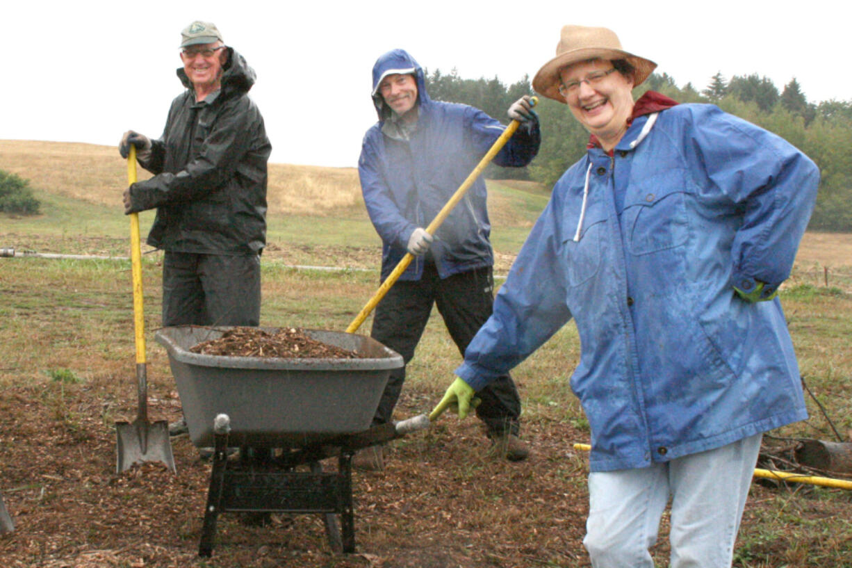 Salmon Creek: About two dozen Salmon Creek United Methodist Church members, including, Bob Cooke, left, and Roger Anderson, joined Pastor Joyce Emery in a &quot;blessing blitz&quot; to haul wood chips for weed control at the 78th Street Heritage Farm.