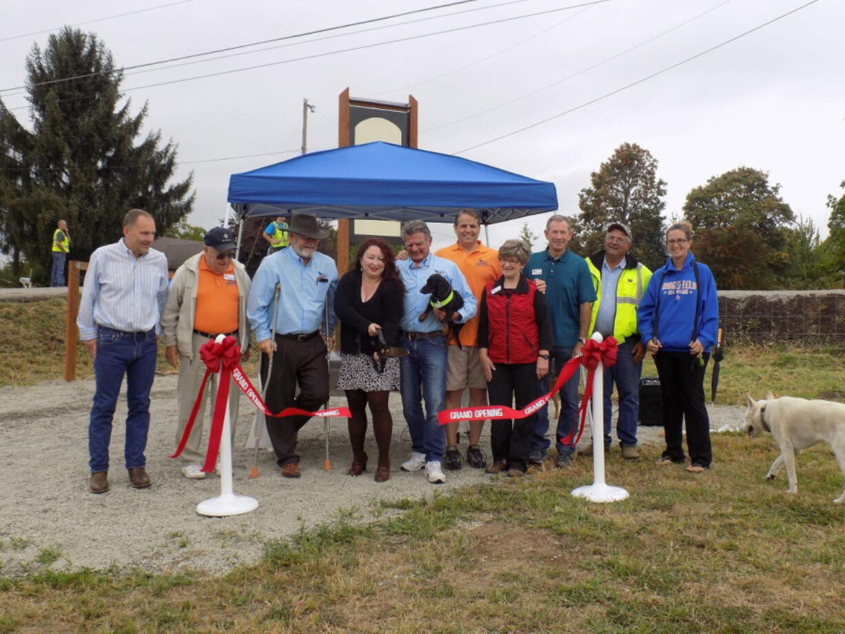 Members of the Ridgefield City Council and parks board cut the ribbon Wednesday for the city&#039;s first off-leash dog park.