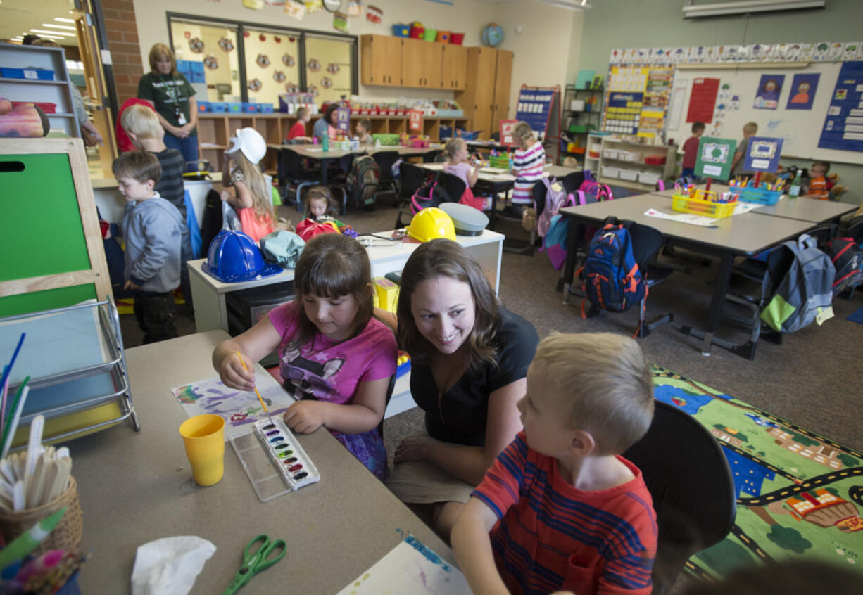 Kindergartner Cheyenne Hall, 5, from left, joins instructional coach Meredith Gannon and classmate Andrew Butler, also 5, on Friday afternoon during playtime at Tukes Valley Primary School in Battle Ground. Gannon was recently honored with the prestigious Presidential Award for Excellence in Mathematics and Science Teaching, administered by the National Science Foundation.