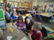 Kindergartner Cheyenne Hall, 5, from left, joins instructional coach Meredith Gannon and classmate Andrew Butler, also 5, on Friday afternoon during playtime at Tukes Valley Primary School in Battle Ground. Gannon was recently honored with the prestigious Presidential Award for Excellence in Mathematics and Science Teaching, administered by the National Science Foundation.