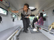 Cascadia Technical Academy criminal justice program participant Kailie Busby, left, and Julissa Ojeda explore a police vehicle at the Girl Cops Are Awesome outreach and recruiting event Thursday at the Vancouver police East Precinct. Busby said she hopes to become a police officer. Top: Four-year-old Brynn Vafus makes a silly face from inside an armored sheriff&#039;s office vehicle at the Thursday event at the Vancouver police East Precinct.