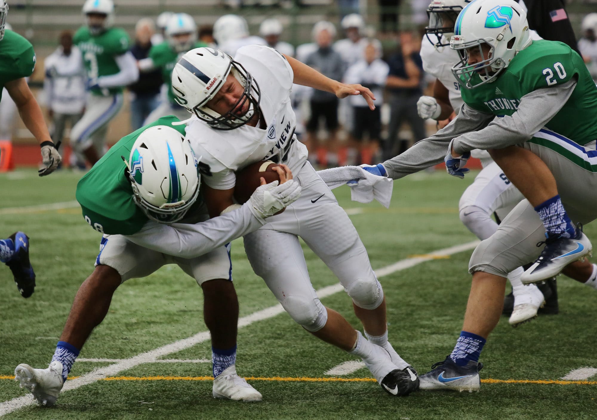 Skyview's Hayden Froeber is tackled by Mountain View's  Cameron Henderson (L) and Payton Regas (R) at McKenzie Stadium in Vancouver Friday September 24, 2016.