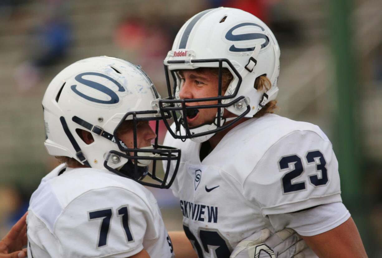 Skyview&#039;s Hayden Froeber (23) celebrates a touchdown with teammate Ryan Hull. Froeber rushed for 209 yards and three touchdowns in a win over Mountain View.