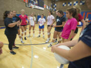 Ridgefield coach Sabrina Dobbs, left, works hard to keep her team's energy up during matches so that they play their best.