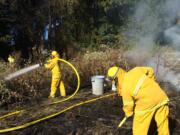 Firefighters respond to a small fire Wednesday afternoon in Brush Prairie that briefly threatened a home.