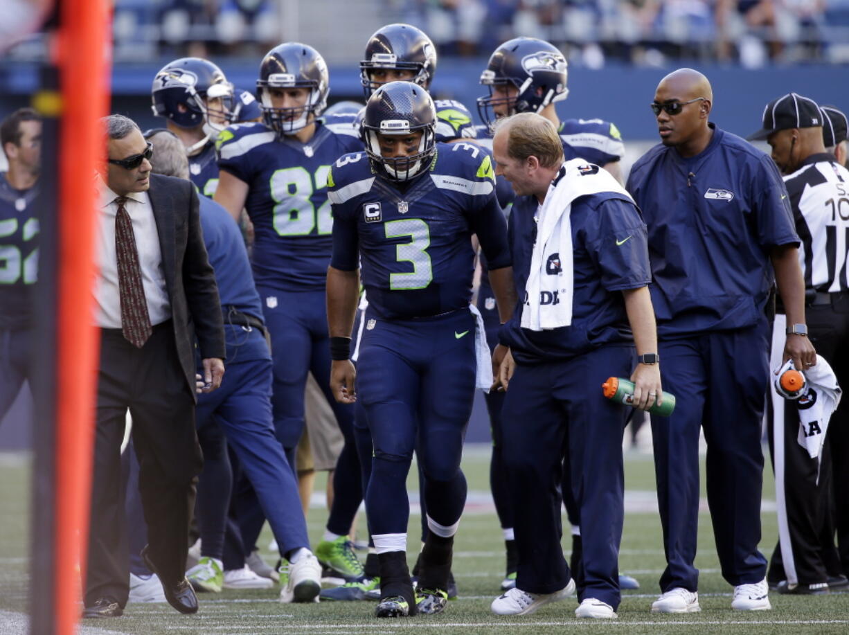 Seattle Seahawks quarterback Russell Wilson (3) is assisted off the field after being brought down against the San Francisco 49ers in the second half of an NFL football game, Sunday, Sept. 25, 2016, in Seattle. (AP Photo/Ted S.