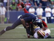 Seattle Seahawks quarterback Russell Wilson, top, is pulled down by San Francisco 49ers&#039; Eli Harold in the second half of an NFL football game, Sunday, Sept. 25, 2016, in Seattle. (AP Photo/Ted S.