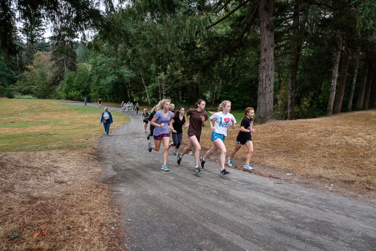 The Battle Ground High School girls cross country team takes advantage of the open space at Lewisville Park for training.