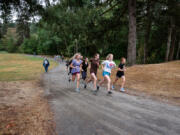 The Battle Ground High School girls cross country team takes advantage of the open space at Lewisville Park for training.