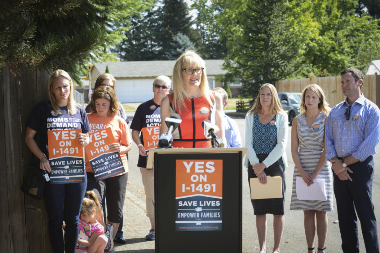 Marilyn Balcerak, whose son fatally shot himself and his stepsister, speaks to media Thursday about Initiative 1491 in the Five Corners area. Initiative 1491 would create extreme-risk protection orders, allowing families and law enforcement to petition a court to temporarily suspend a person&#039;s access to firearms if there is documented evidence that an individual is threatening harm to themselves or others.