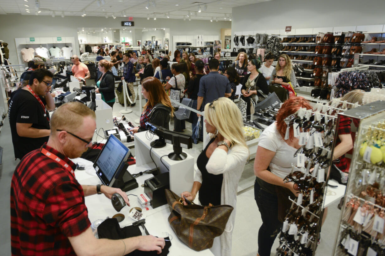 Lines for the cash registers and fitting rooms zigzagged through the store during the grand opening of H&amp;M at Vancouver Mall.