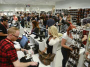 Lines for the cash registers and fitting rooms zigzagged through the store during the grand opening of H&amp;M at Vancouver Mall.