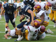 Skyview running back Hayden Froeber is brought down by a trio of O&#039;Dea defenders on Friday at Kiggins Bowl.