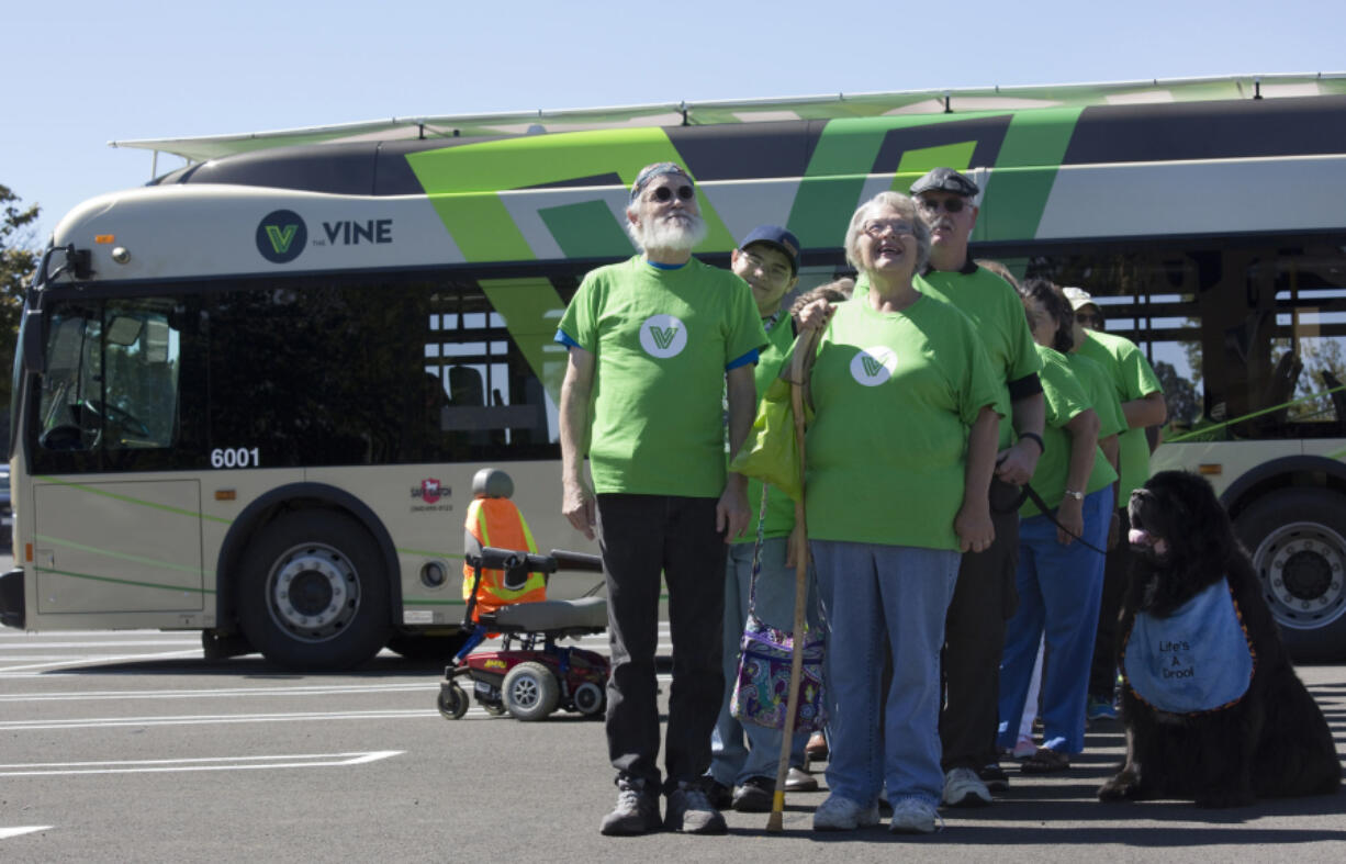 Bob Knaus, left, and Diana Keller line up in formation during the filming of a commercial at Vancouver Mall on Friday for The Vine, C-Tran&#039;s incoming bus rapid transit system.  At top, Alyssa Roehrenback, right, uses a bullhorn to wrangle commercial volunteers into forming the word &quot;VINE&quot; during the filming.