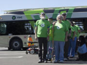 Bob Knaus, left, and Diana Keller line up in formation during the filming of a commercial at Vancouver Mall on Friday for The Vine, C-Tran&#039;s incoming bus rapid transit system.  At top, Alyssa Roehrenback, right, uses a bullhorn to wrangle commercial volunteers into forming the word &quot;VINE&quot; during the filming.