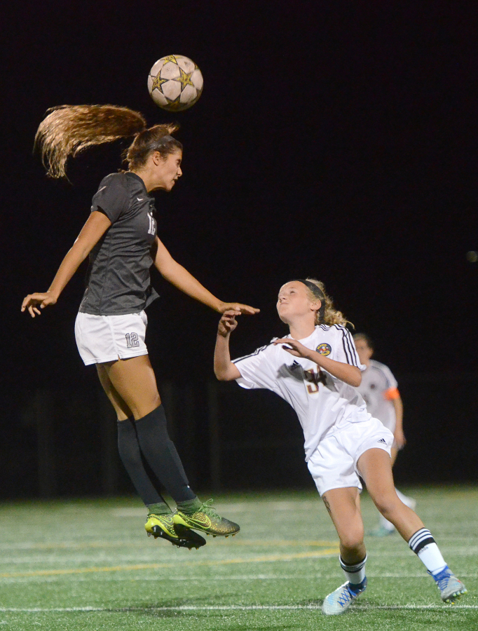 Union senior Angelina Krawczyk heads the ball over Prairie freshman Maya Davis at Prairie High School on Thursday, September 15, 2016. Prairie edged Union 1-0.