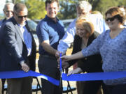 Camas Mayor Scott Higgins, from left, Vancouver Mayor Tim Leavitt, C-Tran board member and Vancouver City Councilor Anne McEnerny-Ogle, and Jill Carrillo, labor representative on the C-Tran board, cut a ribbon Tuesday during a celebration for the recently expanded Fisher&#039;s Landing Transit Center in east Vancouver.