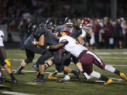 Camas' Will Schultz, center, breaks past Central Catholic's Eli'jah Winston (34) to score a touchdown in the second quarter Friday night, Sept. 2, 2016 at Doc Harris Stadium.