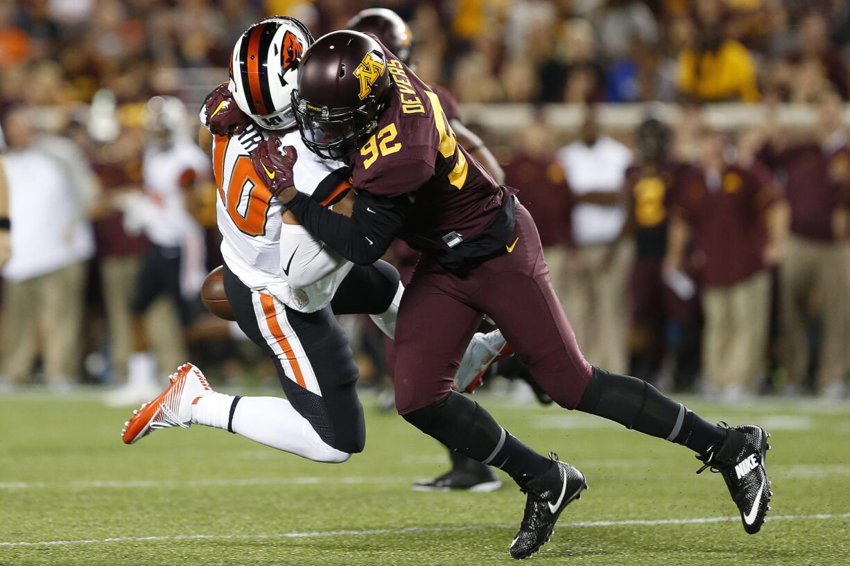 Minnesota defensive lineman Tai'yon Devers (92) sacks Oregon State quarterback Darell Garretson during the the first half of an NCAA college football game, Thursday, Sept. 1, 2016, in Minneapolis.