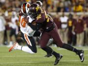 Minnesota defensive lineman Tai'yon Devers (92) sacks Oregon State quarterback Darell Garretson during the the first half of an NCAA college football game, Thursday, Sept. 1, 2016, in Minneapolis.