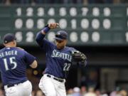 Seattle Mariners Kyle Seager (15) and Robinson Cano share congratulations after the Mariners defeated the Texas Rangers 14-6 in a baseball game Monday, Sept. 5, 2016, in Seattle.