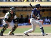 Seattle Mariners' Ketel Marte, right, drives in a run with a single during the ninth inning of a baseball game against the Oakland Athletics, Sunday, Sept. 11, 2016, in Oakland, Calif.