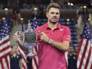 Stan Wawrinka, of Switzerland, holds up the championship trophy after beating Novak Djokovic, of Serbia, to win the men's singles final of the U.S. Open tennis tournament, Sunday, Sept. 11, 2016, in New York.