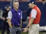 Washington coach Chris Petersen, left, talks to Arizona coach Rich Rodriguez before an NCAA college football game, Saturday, Sept. 24, 2016, in Tucson, Ariz.