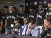 David P. Samson, center, president of the Miami Marlins, covers his face during press conference to announce the death of Marlins pitcher Jose Fernandez. Fernandez, the ace right-hander for the Miami Marlins who escaped Cuba to become one of baseball's brightest stars, was killed in a boating accident early Sunday morning. Fernandez was 24.