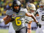 Oregon wide receiver Charles Nelson (6) scores a touchdown during the third quarter against UC Davis during an NCAA college football game in Eugene, Ore., Saturday, Sept. 3, 2016.