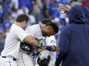 Seattle Mariners&#039; Mike Zunino, left, holds Robinson Cano as other players douse Cano with water after his game-winning sacrifice fly against the Toronto Blue Jays on Wednesday in Seattle. The Mariners won 2-1 in 12 innings to remain in the hunt for an American League wild card.