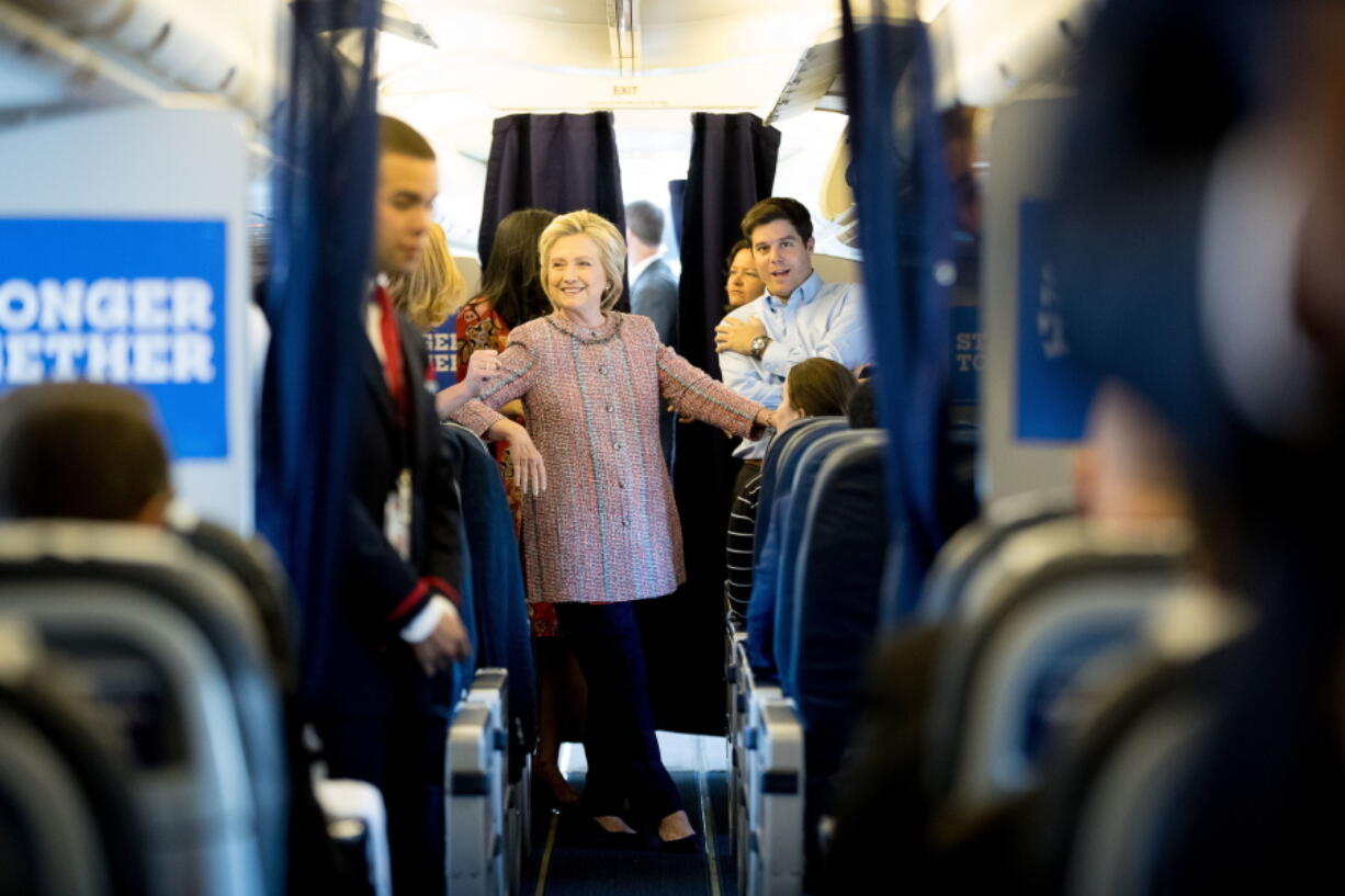 Democratic presidential candidate Hillary Clinton smiles as she speaks to aids on her campaign plane, in White Plains, N.Y., Thursday, before traveling to Greensboro, N.C. for a rally. Clinton returned to the campaign trail after a bout of pneumonia that sidelined her for three days and revived questions about both Donal Trump&#039;s and her openness regarding their health.