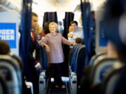 Democratic presidential candidate Hillary Clinton smiles as she speaks to aids on her campaign plane, in White Plains, N.Y., Thursday, before traveling to Greensboro, N.C. for a rally. Clinton returned to the campaign trail after a bout of pneumonia that sidelined her for three days and revived questions about both Donal Trump&#039;s and her openness regarding their health.