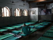 An inmate sits on his bed at &#039;Nirmal Hriday Kalighat, Mother Teresa&#039;s home for the dying and destitute in Kolkata, India, on Friday.