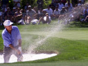 Arnold Palmer chips a shot out of a bunker on the eleventh hole of the Fred Meyer Challenge in Aloha, Ore., on Aug. 23, 1999.